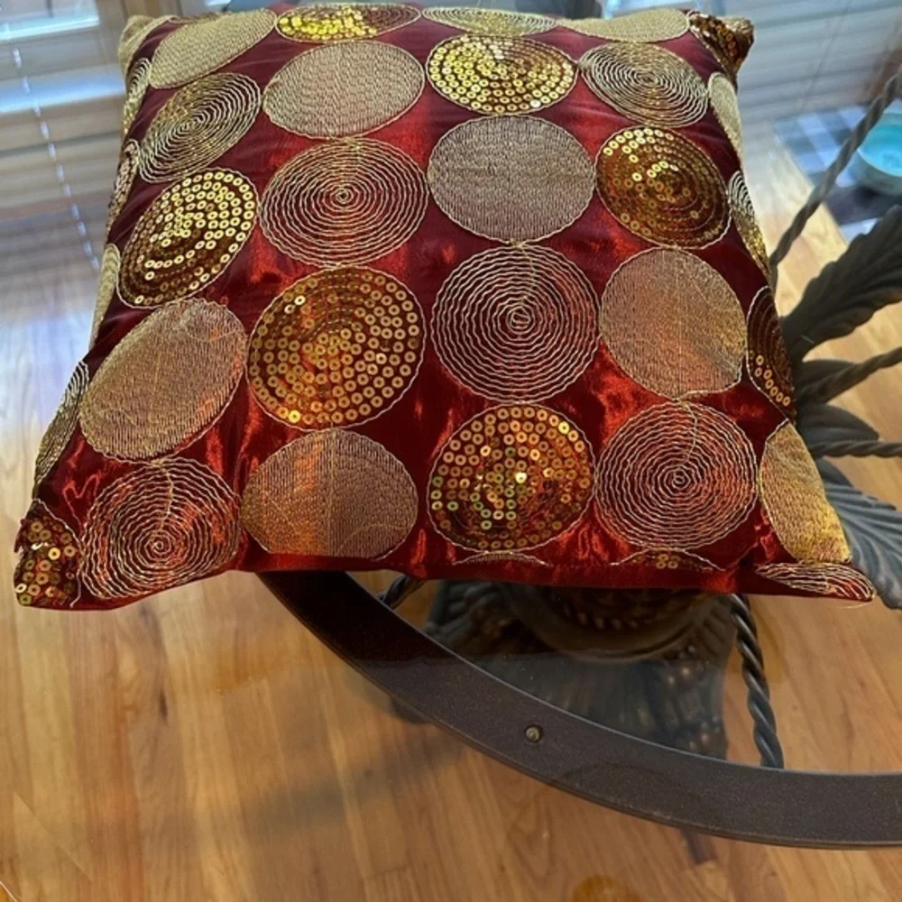 Dark red pillow with gold accents